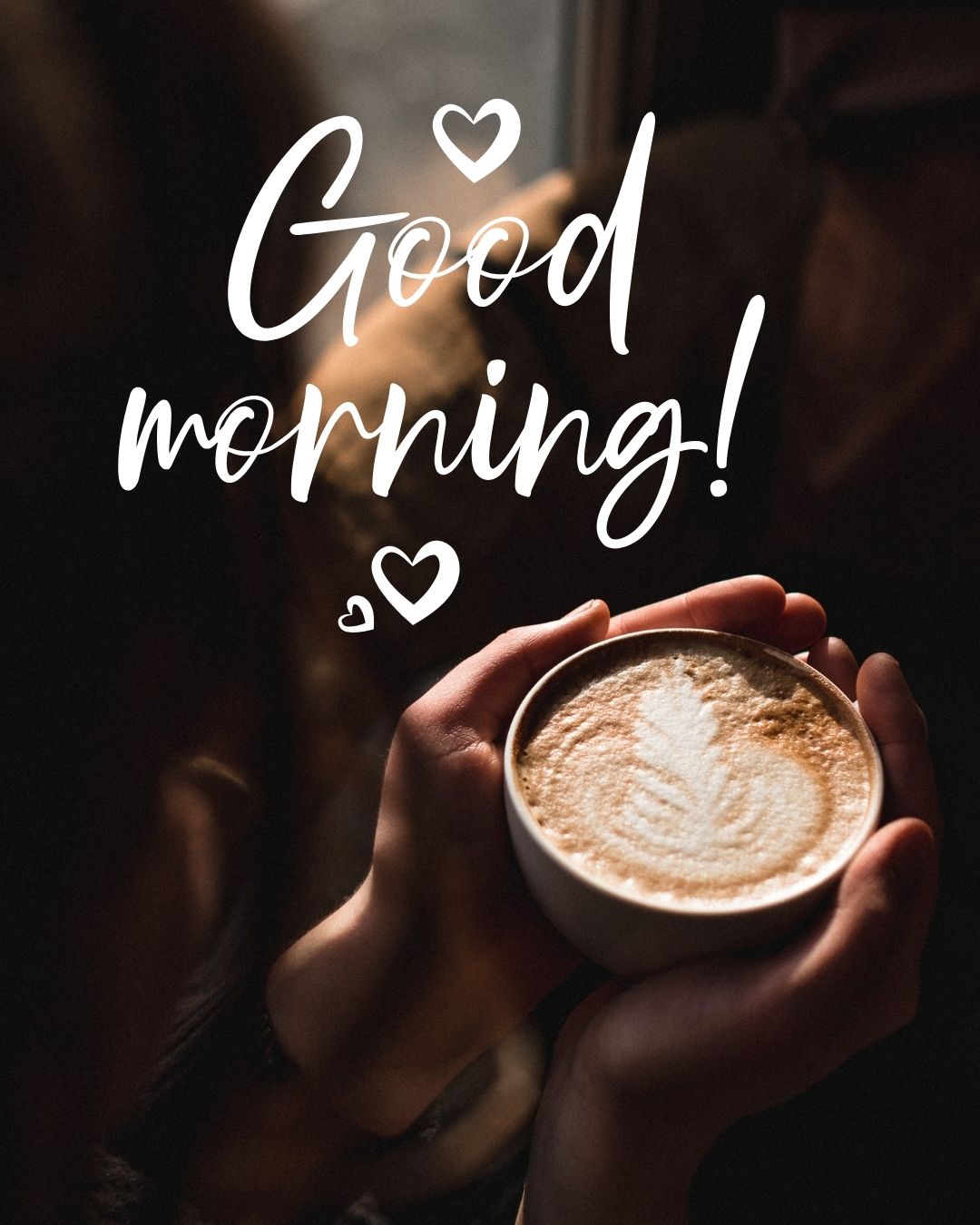 A person holding a latte with leaf latte art, "Good Morning" text overlay with hearts.