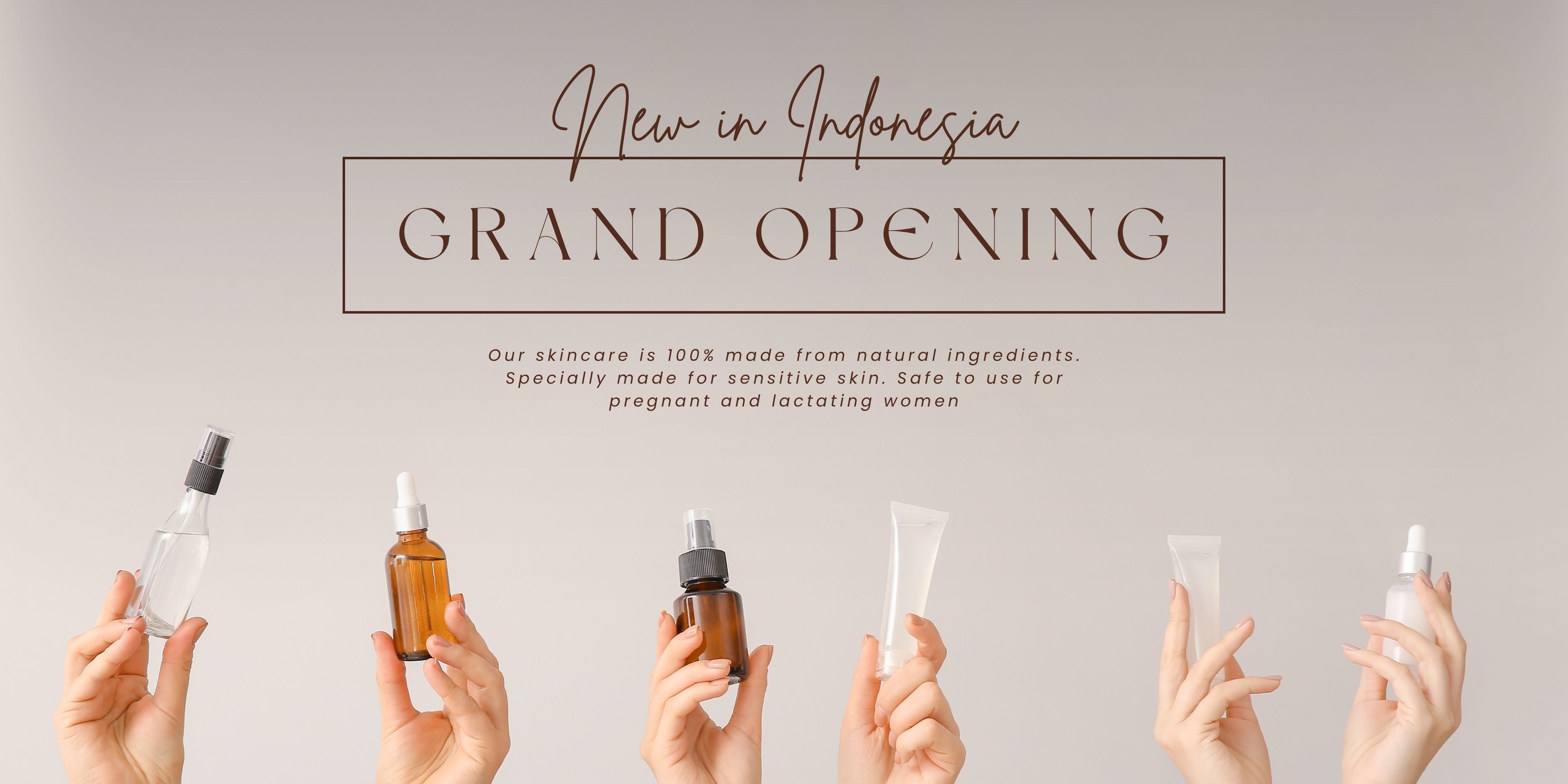 Hands holding various natural skincare products including sprays, dropper bottles, and creams against a light background.